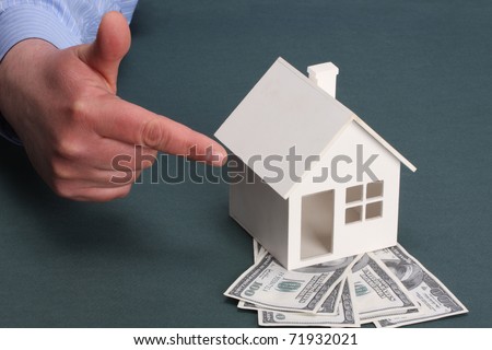 parts of hands with house and money