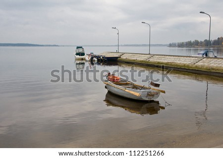 Lonely boat in the autumn lake