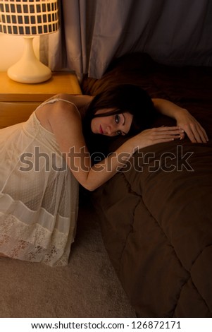 Beautiful Woman in Nightgown Leaning on Bed