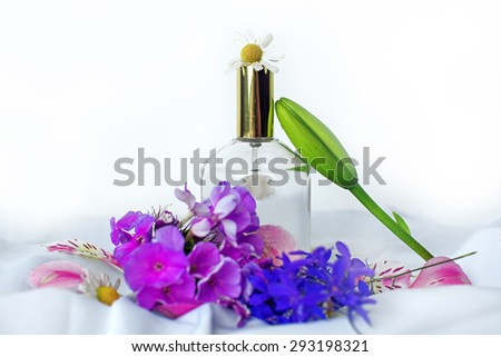 perfume and wild flowers on a white background