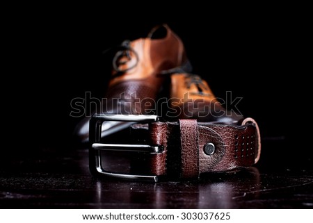 belt with a simple buckle on wooden background close up