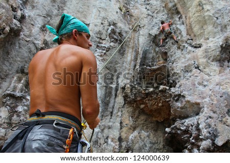 KRABI, THAILAND - JANUARY 25 : Rock climbing on Railay beach on January 25, 2011 in Krabi, Thailand. Railay beach is one of the most popular rock climbing locations in Asia.