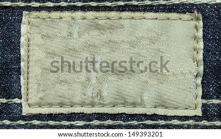 Blank leather jeans label sewed on a jeans. Can be used as background for your text.