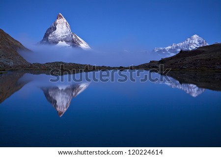 MIRROR MIRROR. the Matterhorn floating above the clouds and mirroring in the Riffelsee lake.