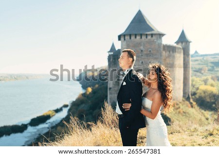 Walk just married on the background of the old castle