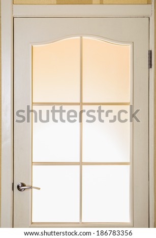 A glass door with a strong light behind it