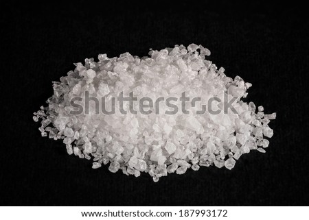 A heap of sea salt on black background