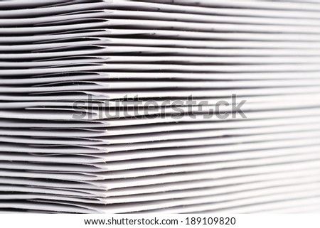 A pile of DVDs and CDs in white envelopes