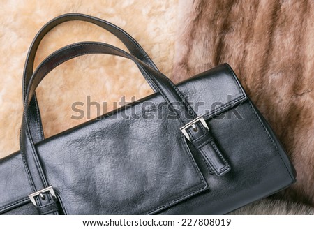 A black leather bag of warm blond sheepskin, blue fox and red sable mink furs