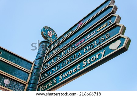 York, United Kingdom - August 9, 2014: Closeup on tourist Sign posts in city of York, UK.York is a historic walled city at the confluence of the Rivers Ouse and Foss in North Yorkshire, England.