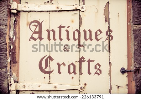 Old wooden sign with Antiques and Crafts