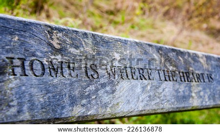 Home is where the heart is inscription carved in wooden board