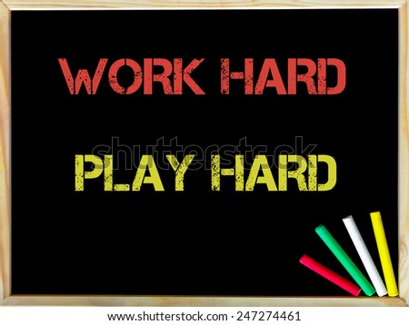 Work Hard Play Hard, vintage chalk text on blackboard, colored chalk in the corner, Lifestyle conceptual image