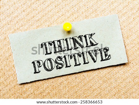 Recycled paper note pinned on cork board.Think positive Message. Concept Image