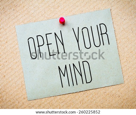 Recycled paper note pinned on cork board. Open Your Mind Message. Concept Image