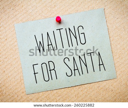 Recycled paper note pinned on cork board. Waiting for Santa Message. Concept Image