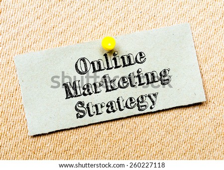 Recycled paper note pinned on cork board. Online Marketing Strategy Message. Concept Image