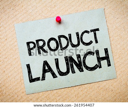 Recycled paper note pinned on cork board. Product Launch Message.Business Concept Image