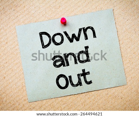 Down and Out Message. Recycled paper note pinned on cork board. Concept Image