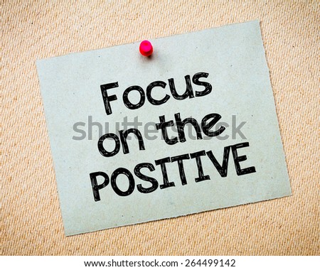 Focus on the positive Message. Recycled paper note pinned on cork board. Concept Image