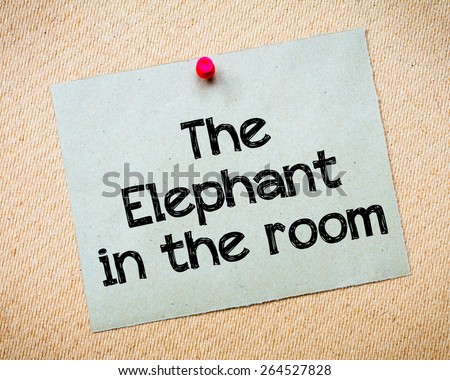 The Elephant in the room Message. Recycled paper note pinned on cork board. Concept Image