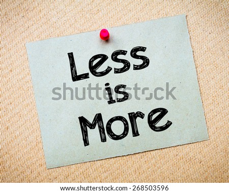 Less is More Message. Recycled paper note pinned on cork board. Concept Image