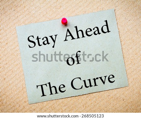 Stay Ahead of the Curve Message. Recycled paper note pinned on cork board. Concept Image