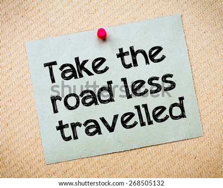 Take The Road Less Travelled Message. Recycled paper note pinned on cork board. Concept Image