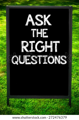 ASK THE RIGHT QUESTIONS  message on sidewalk blackboard sign against green grass background. Copy Space available. Concept image