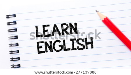 Learn English Text written on notebook page, red pencil on the right. Concept image