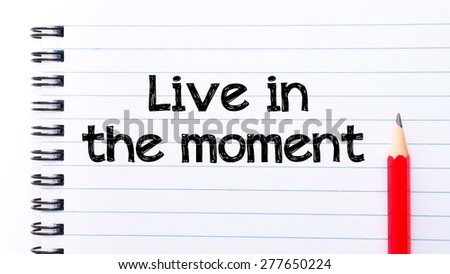 Live in the Moment Text written on notebook page, red pencil on the right. Motivational Concept image