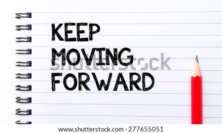 Keep Moving Forward Text written on notebook page, red pencil on the right. Motivational Concept image