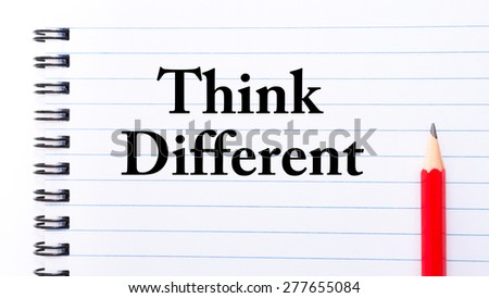 Think Different Text written on notebook page, red pencil on the right. Motivational Concept image