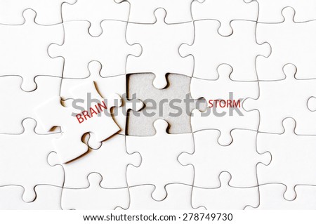 Missing jigsaw puzzle piece completing word BRAINSTORM. Business concept image for completing the final puzzle piece.