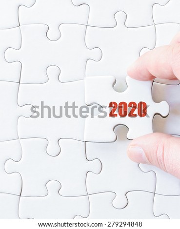 Missing jigsaw puzzle piece with  year  2020. Business concept image for completing the puzzle.