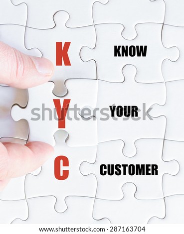 Hand of a business man completing the puzzle with the last missing piece.Concept image of Business Acronym KYC as Know Your Customer