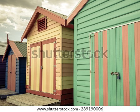 Bathing houses at Brighton Beach, Australia. View of colorful beach huts with retro color filter applied, summer vacation concept