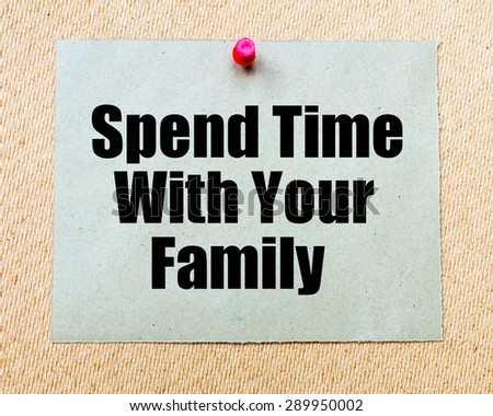 Spend Time With Your Family written on paper note pinned with red thumbtack on wooden board. Motivation conceptual Image