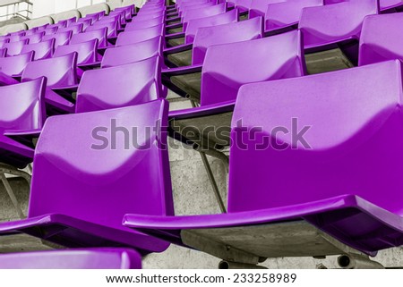 row of purple plastic chairs that disappear into the distance
