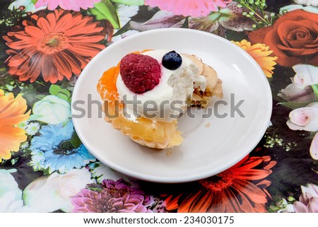 an delicious cake of strawberry, pineapple, banana, orange, kiwi and whipped cream