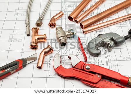 Plumbing Tools Arranged On House Plans whit copper tubes