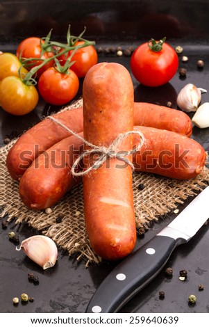 Raw sausages fresh tomatoes and spices