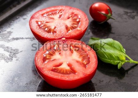 halved tomatoes with basil leave