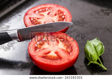 cut tomatoes with basil leave