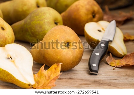 cut pears on wooden background