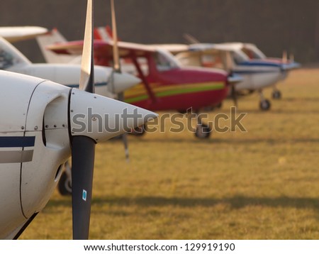 Row of planes\' propellers at autumn sunset