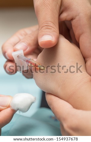 Intravenous injection in a baby hand