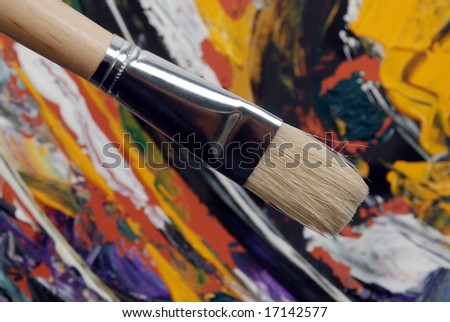 Painting brush over abstract colored background