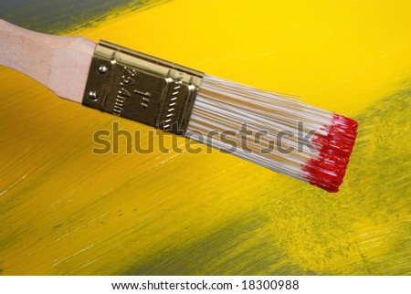 Wood painting brush over abstract colored background