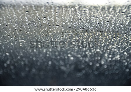 Selective focus natural rain drops on glass window with vintage color